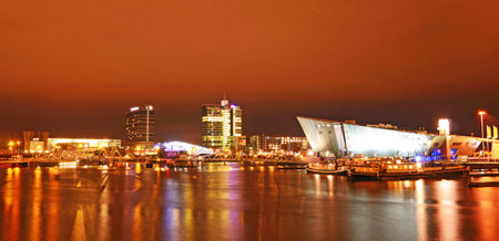 Beautiful landscape of boats and modern buildings on the channel in evening Amsterdamのeditorial素材