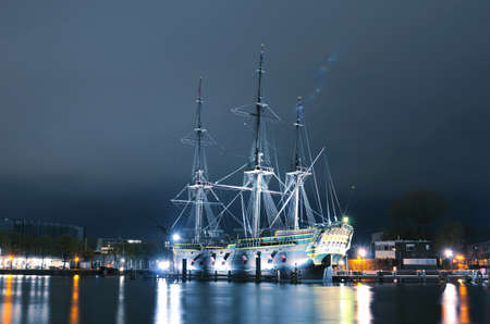 Beautiful landscape with old sailing ship on the channel in evening Amsterdamのeditorial素材