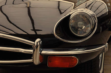 Interesting design of old car with original headlight and bumper chrome close-up.のeditorial素材