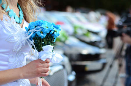 Flowers in the hands of the bride during the wedding ceremonyの写真素材