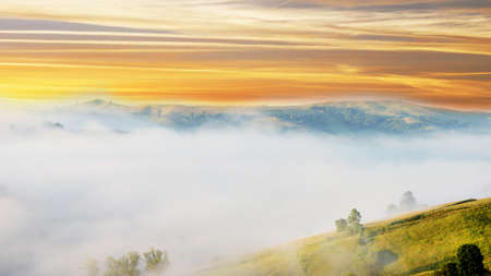 Magic landscape at sunrise in the mountains in the fogの写真素材