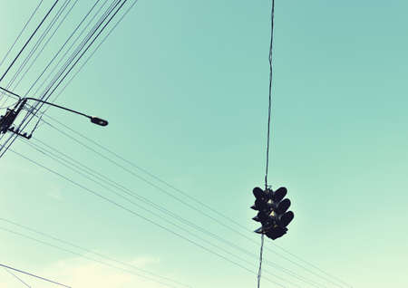 Abstract Composition with traffic light and wires against the sky. Vintage style.の写真素材