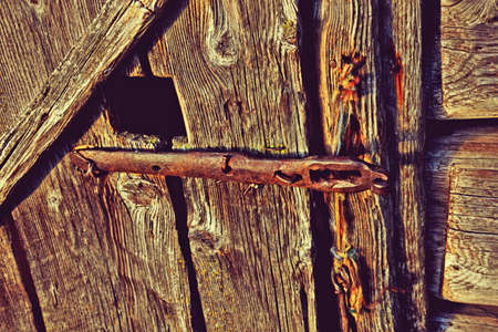 Rusted metal latch on the old wooden door. Grunge style.の写真素材