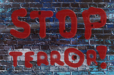 The inscription on the wall of graffiti with the slogan Stop terrorism (acts of terrorism, threat -...