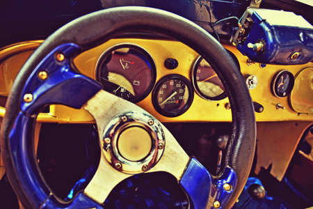 Fragment of interior retro car with speedometer, toggle switches and steering. vintage styleの写真素材
