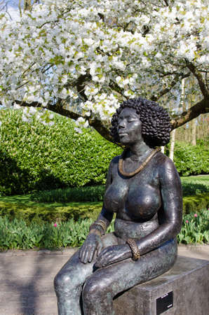 The tree blooms. Monument in the park Keukenhof, Holland, Europe. (harmony, peace, meditation - concept)の写真素材