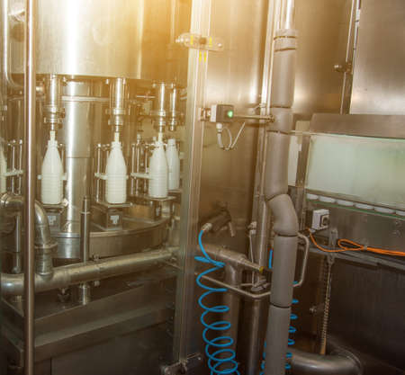 Mechanism-line for bottling milk in bottles on a modern dairy plantの写真素材