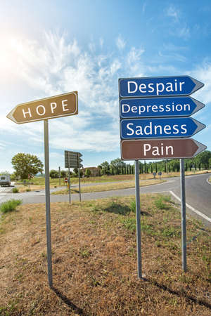 Road signs with the inscription "Hope", "Sadness", "Pain", "Depression", "Despair"の写真素材