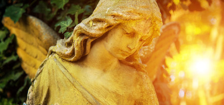 The figure of an angel in a golden glow. Symbol of love, invisible forces, purity, enlightenment,...