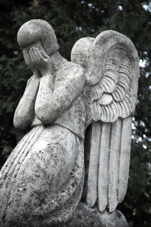 The figure of an angel who cries. Symbol of sorrow, love, invisible forces, purity, enlightenment, ministry. Guardian.の写真素材