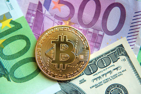 bitcoin on dollar and euro bills (investment, exchange rate, wealth, luxury, success, stock exchange - concept)の写真素材