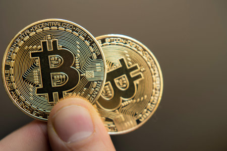 two bitcoins in hand (Investment, course change, rise, decline, luxury, success, stock exchange -...