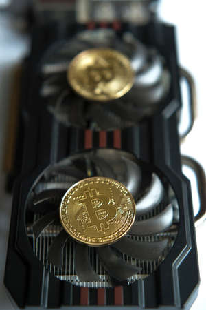 Bitcoins on fans of a computer graphics card (mining - concept)の写真素材