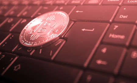 Bitcoin on a computer keyboard (landing crypt, exchange, investment, training, seminar - concept)の写真素材