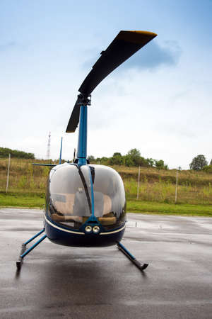 blue helicopter near the fieldの写真素材