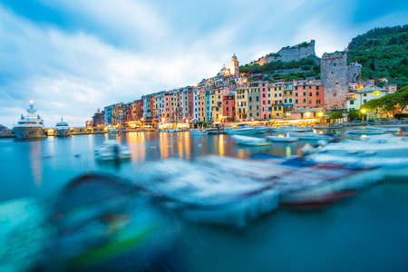 Mystic landscape of the harbor with colorful houses in the boats in Porto Veneto, Italy, Liguria in the evening in the light of lanternsの写真素材