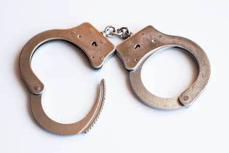 Open cufflinks close-up as a symbol of release from the responsibility of criminals and the avoidance of punishment for the committed crimesの写真素材