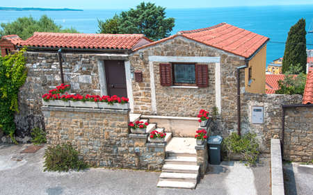 Beautiful landscape with a cozy little house with flowers in Porec, Croatia tourist centerの写真素材