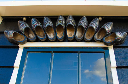 Dutch colored clips like decoration over the window frame on the wall of the house