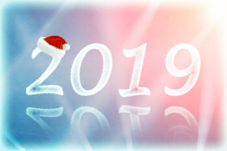 The numbers of snow in Christmas hat with rays of light  (2019, New Year card - concept).