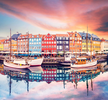 Breathtaking beautiful scenery with boats in the famous Nyhavn in Copenhagen, Denmark at sunrise....