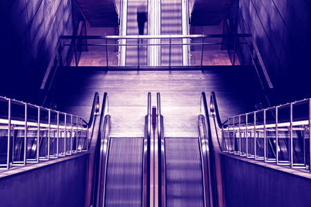 Abstract image with black silhouette on the subway escalator as a symbol of moving forward, getting out of depression, advancing and achieving life goalsの写真素材