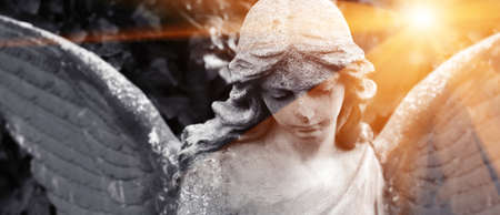 Abstract image with background and place for caption and fragment of tragic sad american angel and rays of sun and hope. Black and white concept.の写真素材