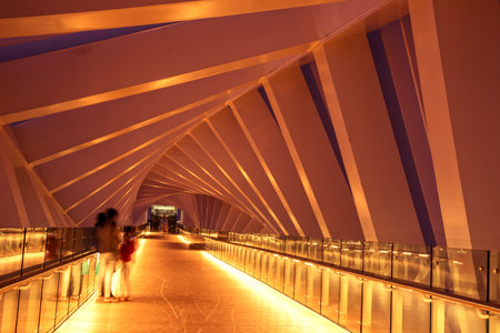 Interior of Modern twisted bridge over the Dubai Water Canal with silhouettes in United Arab Emirates.の写真素材