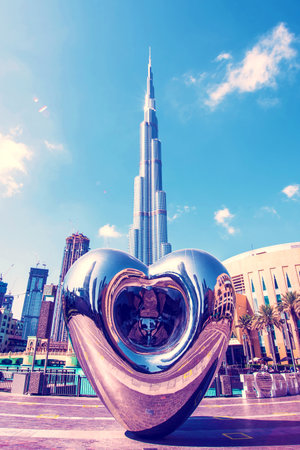 Dubai, United Arab Emirates â February 10, 2021: A modern monument in the form of a mirror drop of metal or water in the background Burj Khalifa Tower.のeditorial素材
