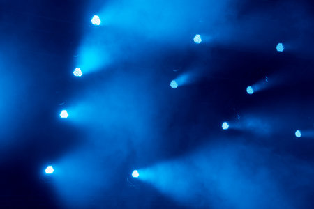 abstract magic image with rays of colored light from the spotlights in the darkの写真素材