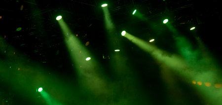 abstract magic image with rays of colored light from the spotlights in the darkの写真素材