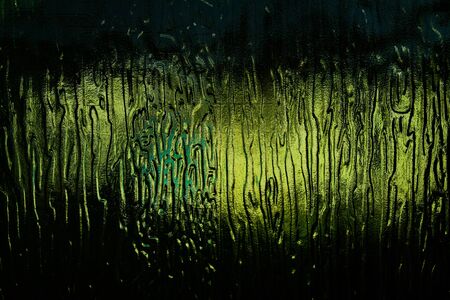 The light through the dark green glass with abstract patternの写真素材