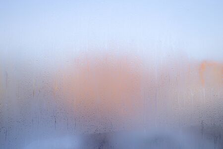The background texture and drops of moisture on the surface of the glassの写真素材