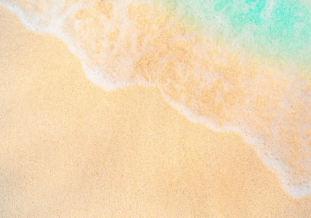 Soft wave of the sea on the sandy beach. Summer background.