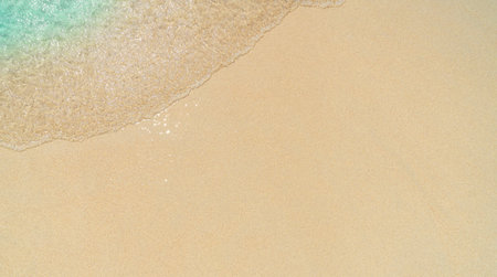 Soft wave of sea on sandy beach background. Top view, copy spaceの写真素材