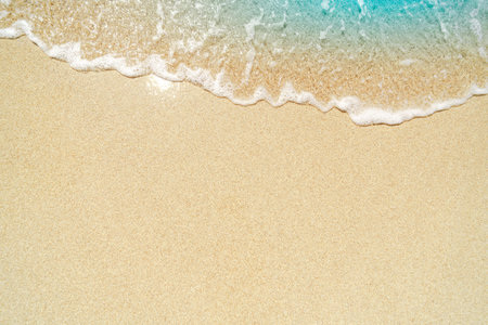 Soft wave of the sea on the sandy beach. Summer background.