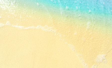 Beach sand and sea wave background. Top view with copy space
