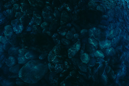 dark water with stones at bottom seaの写真素材
