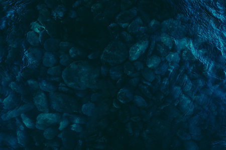 abstract blue background with pebbles in the water, top viewの写真素材