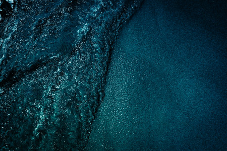 Blue sea water with waves and foam. Natural background. Toned.の写真素材