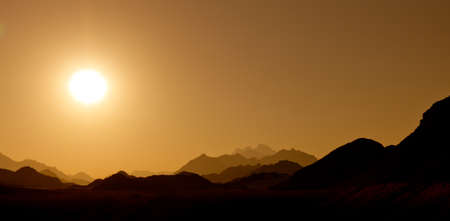Sunset in the desert mountainsの写真素材