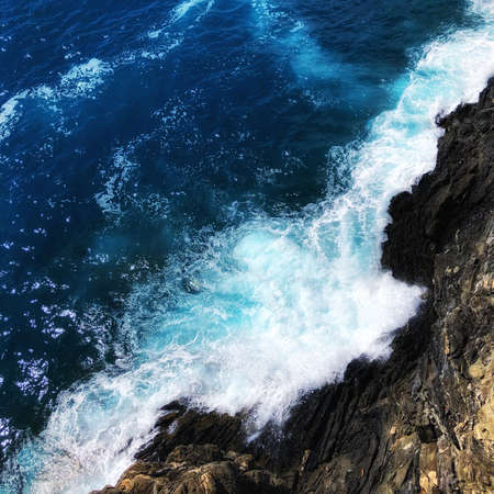 Waves crashing into a cliffの写真素材