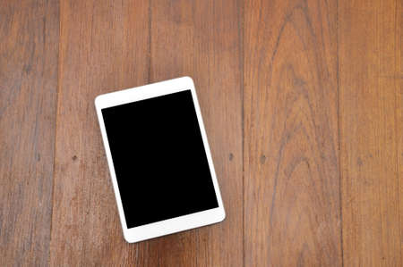 White Cell phone On Wooden Background.の写真素材