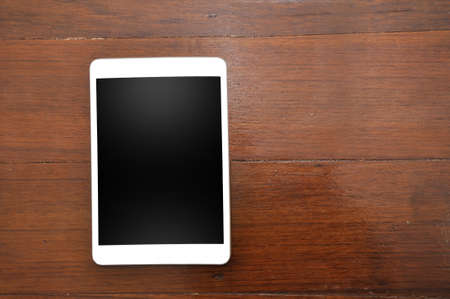 White tablet On Orange Wooden Background.の写真素材