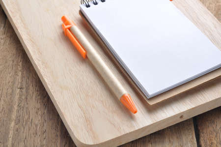 blank note paper  and orange pencil on block.の写真素材