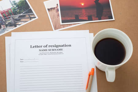 Letter of resignation document and coffee cup on brown background.の写真素材