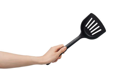 left hand holding spade of frying pan on white background.の写真素材