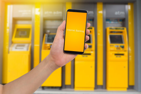 human hand hold smart phone, tablet, cellphone with virtual app internet banking on blurry Automatic...