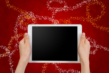 human hand hold  smartphone, tablet, cell phone with blank screen on shinning cycle bokeh and red background , concept of Communication on Christmas day.の写真素材