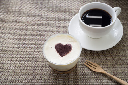 Kitchen table with Pie Banana and sweet cream cake, black coffee and dessert on the table, Concept of valentine food.の写真素材